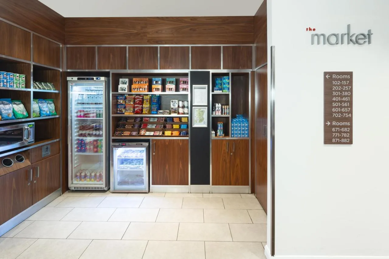 a grocery store aisle with a refrigerator and a chalkboard at Courtyard by Marriott Edinburgh in Edinburgh