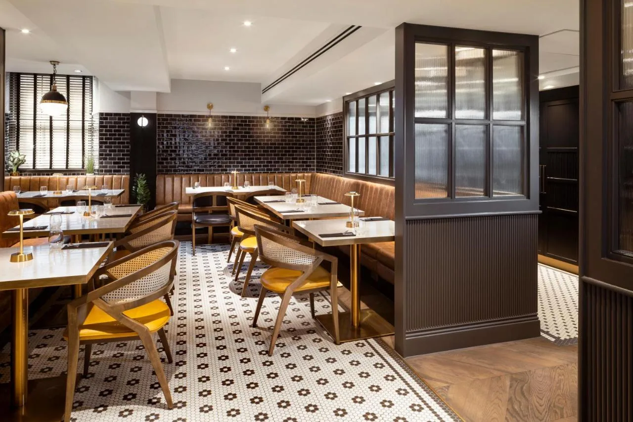 a dining room with tables and chairs in a restaurant at Courtyard by Marriott Edinburgh in Edinburgh
